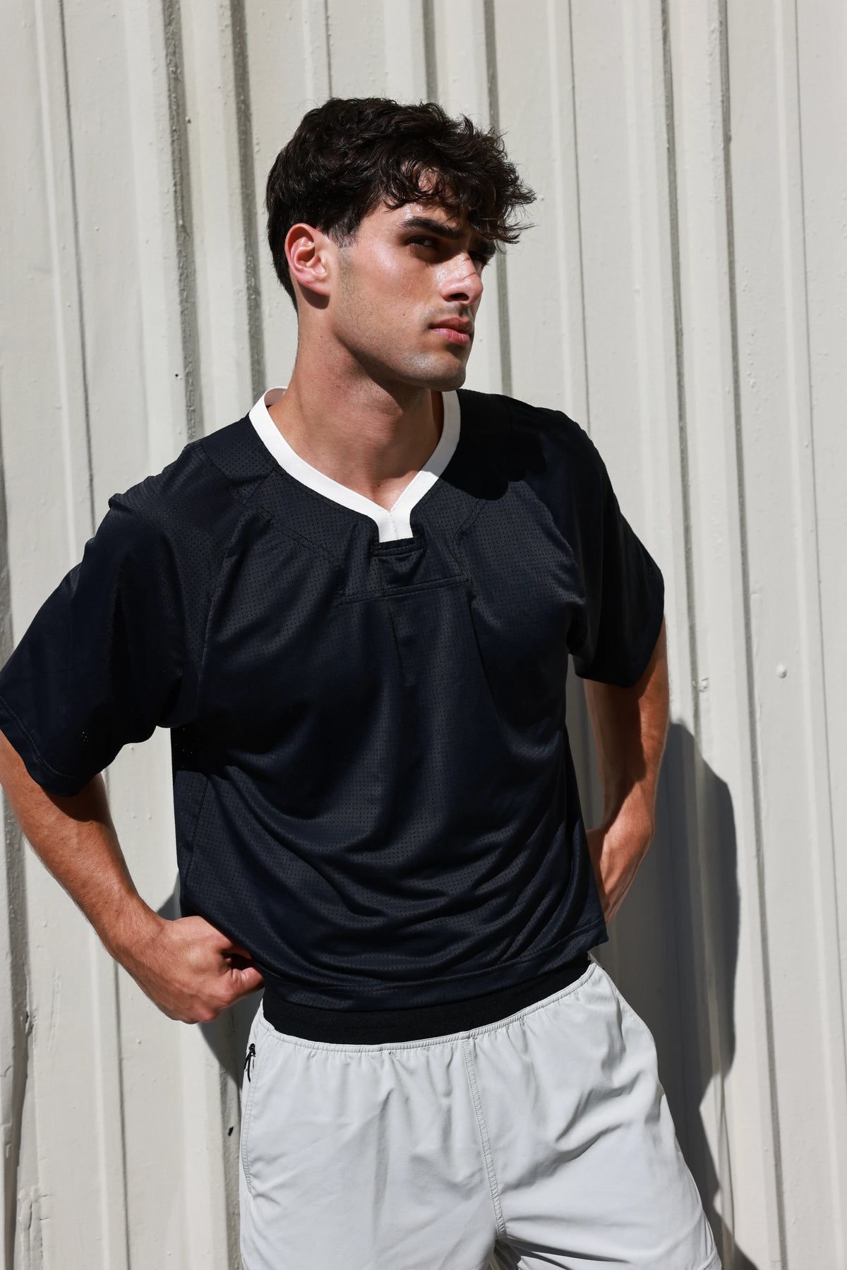 PODIO Midnight Boxy Semi-Cropped Training Tee on model, three-quarter