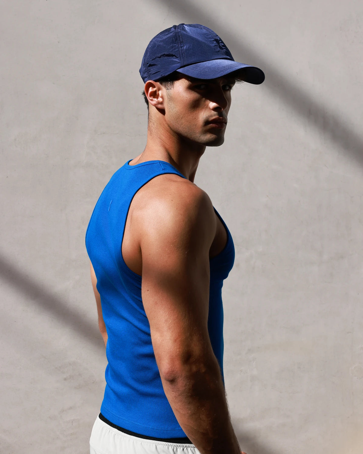 PODIO Volt 3-Pack Tanks — blue ribbed muscle tank on model, side view