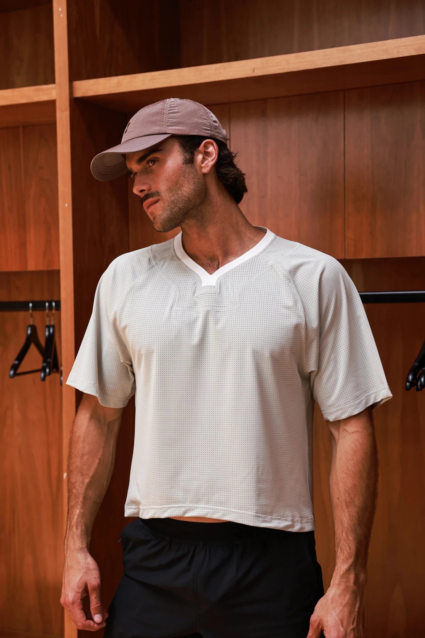 Bone-colored PODIO boxy semi-cropped training tee with a relaxed fit, featuring short sleeves and a crew neckline.