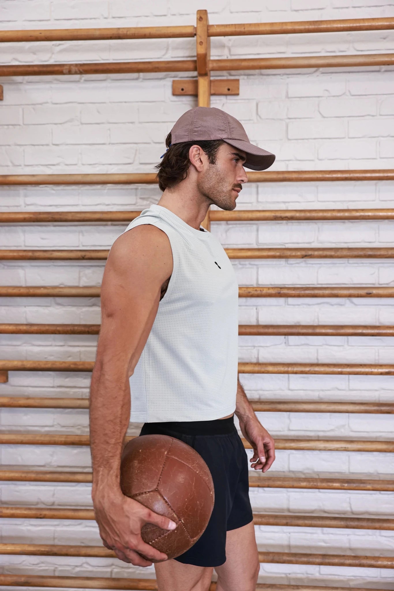 Bone semi-cropped training tank top by PODIO, featuring a fitted design and breathable fabric for active wear.